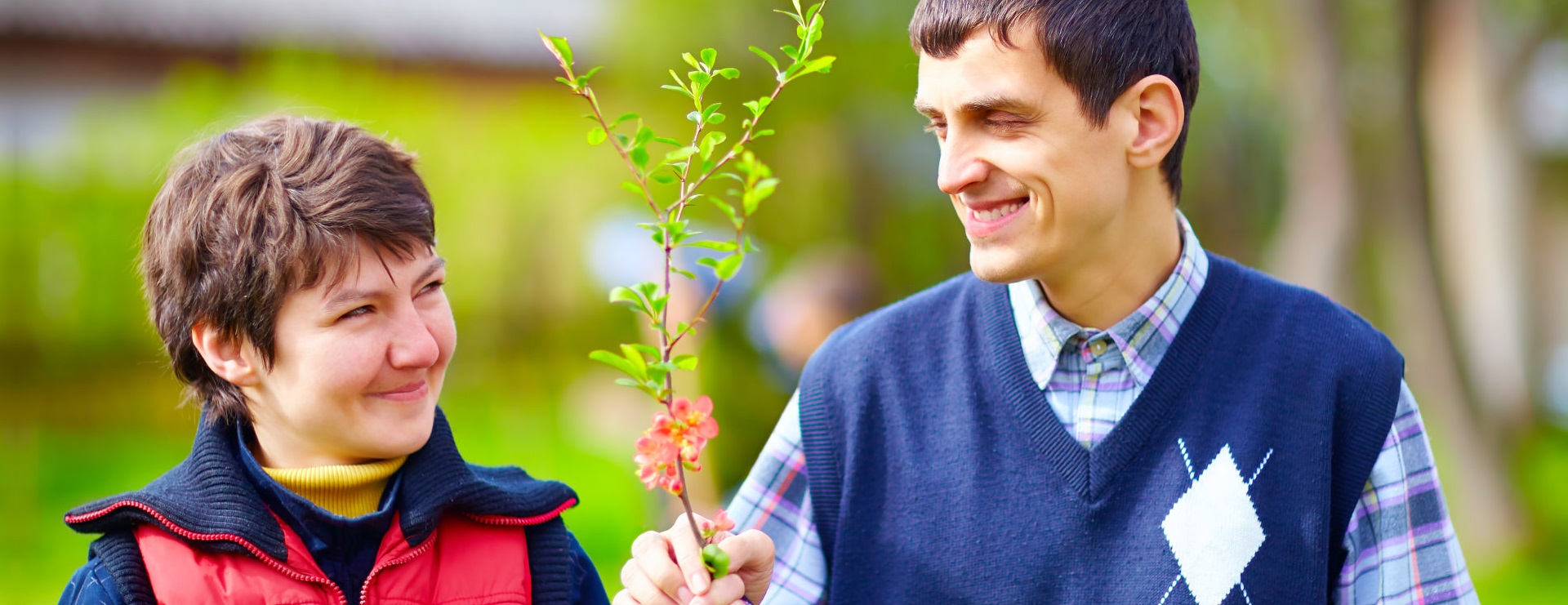 man giving a flower to a caregiver