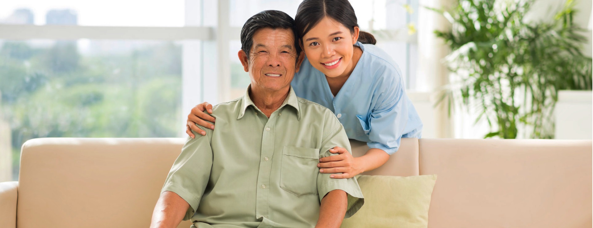 senior man and a caregiver smiling