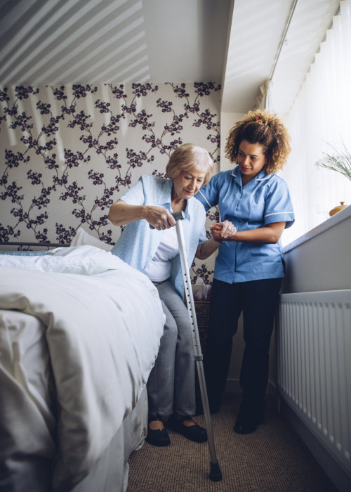 lady caregiver assisting the old woman